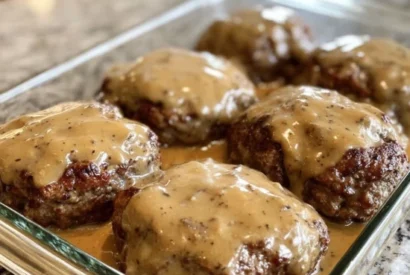 Thumbnail for Amish Hamburger Steak Bake A Hearty, Savory, and Comforting Oven-Baked Dinner Smothered in a Rich Onion and Mushroom Gravy